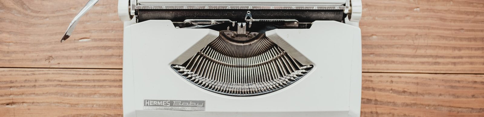 white and black typewriter on table